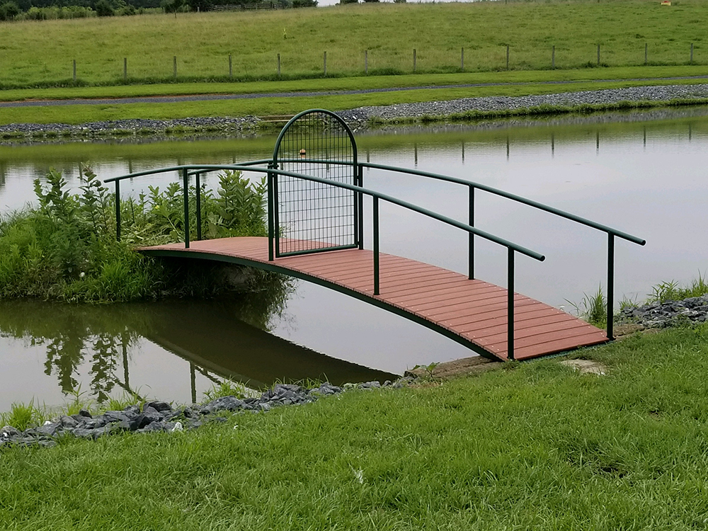 Steel bridge frame fabricated by Bryan Tool for a farm pond