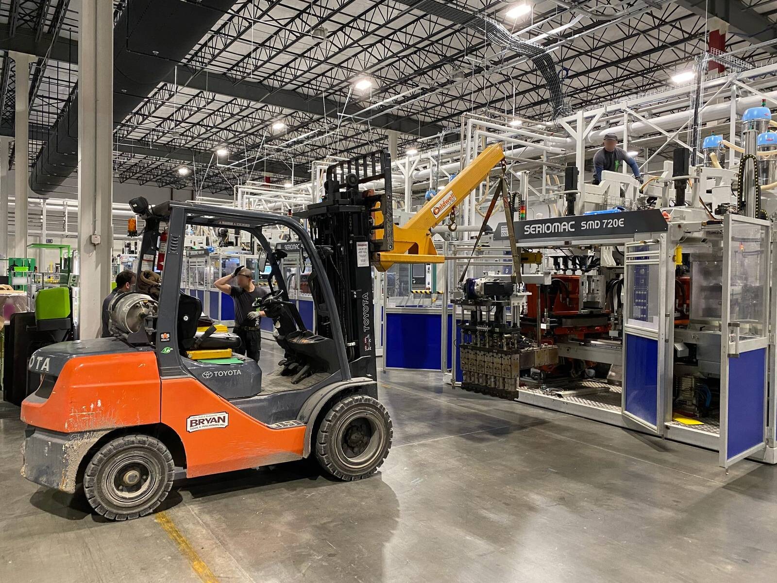 Bryan Tool forklift with boom attachment removing the head from an extrusion machine