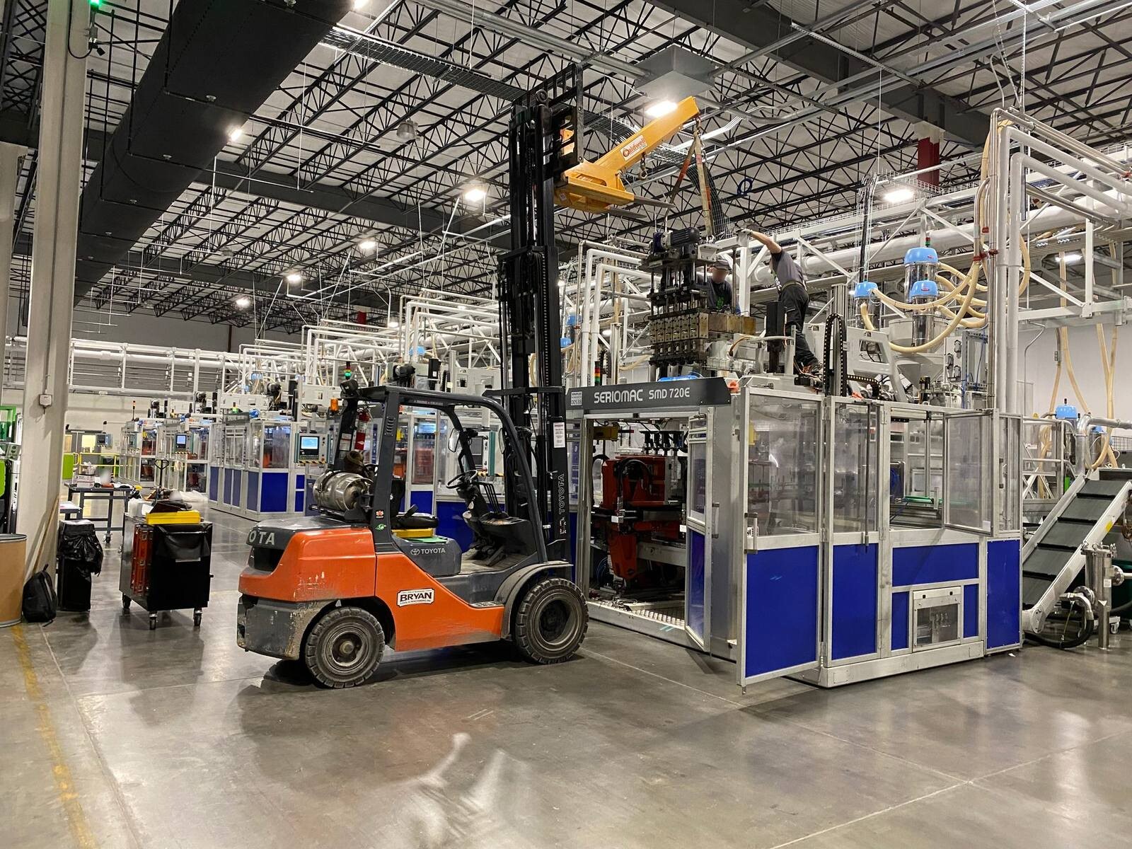 Bryan Tool crew removing an extruder head inside a customer plant