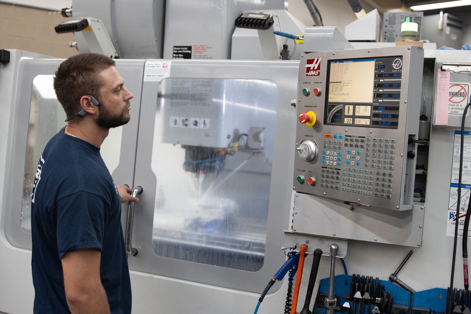 A Bryan Tool machinist at his Haas CNC machining center
