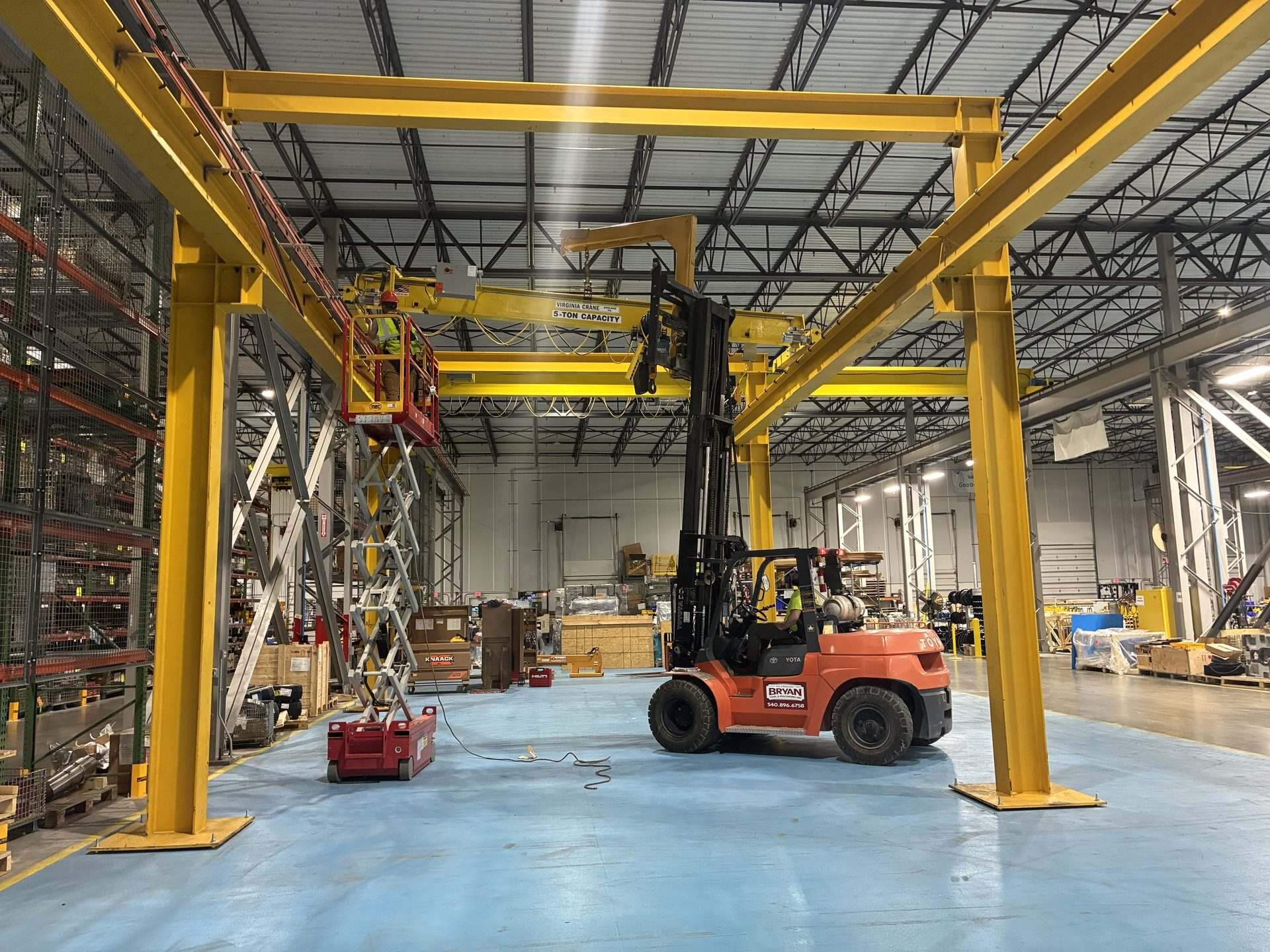 Bryan Tool crew installing overhead structural steel in a customer warehouse